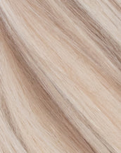 A close-up of butter blonde hair extensino color showcasing the soft, luxurious texture.